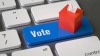 Image of a computer keyboard with a blue button that says "Vote."